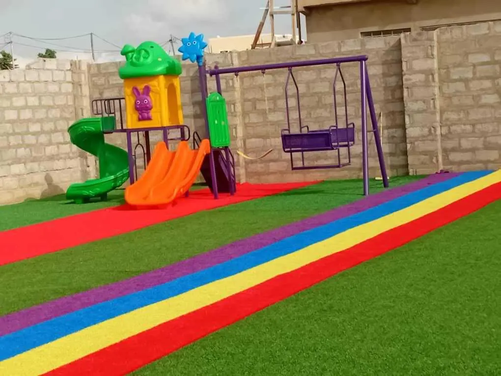 AEIS playground with slides, swings and a rainbow track